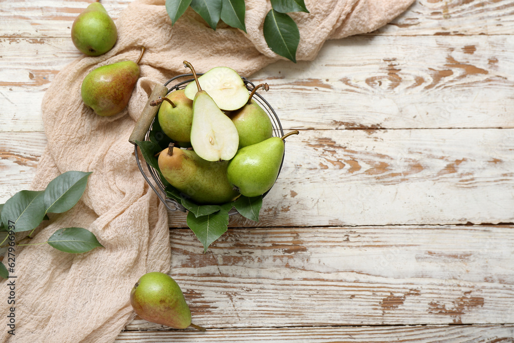 Basket with ripe pears on wooden table