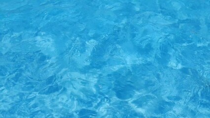 Poster - Blue water in the pool with sun glare.
