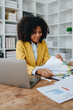 © Jirapong - financial, Planning, Marketing and Accounting, portrait of african american employee checking financial statements using documents and calculators at work