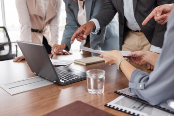 Hands, meeting and business people with a laptop and report for analysis, investment or trading. Discussion, computer and corporate employees at a desk for teamwork on financial analytics together