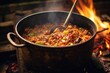 wooden spoon stirring jambalaya in a pot over fire