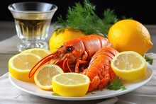 A Steamed Lobster On A White Plate With Lemon Slices