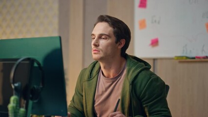 Wall Mural - Talking freelancer watching monitor at workplace close up. Guy staring computer