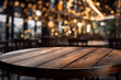 Empty dark oak wood table top, blurred background in a bar or restaurant 