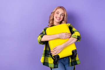 Sticker - Photo of cute dreamy lady wear plaid yellow shirt hugging suitcase looking empty space isolated violet color background