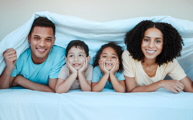 Poster - Blanket, bed and portrait of parents with children for bonding, quality time and affection in morning. Love, family and happy mother, father and kids laying in bedroom for fun, playful and relaxing