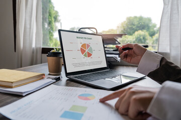 Wall Mural - Businessman hands are analyzing charts, graphs, financial data. and accounting documents The displayed data calculates the planning strategy