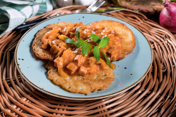 Wall Mural - Homemade potato pancakes with goulash.