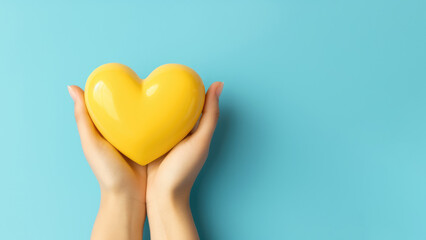 Overhead view of yellow heart in hands isolated on blue background. AI Generated.