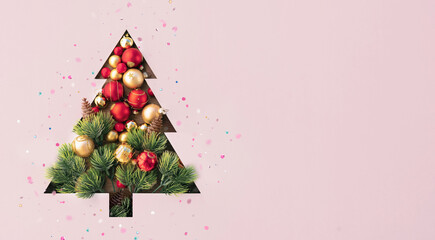 Wall Mural - Creative Christmas tree with golden and red balls isolated on pink background. Banner for New Year's greetings.