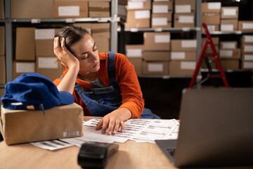 Wall Mural - Tired stress woman worker labor working in warehouse cargo inventory industry sleep on workplace at the table. Overwork and overtime