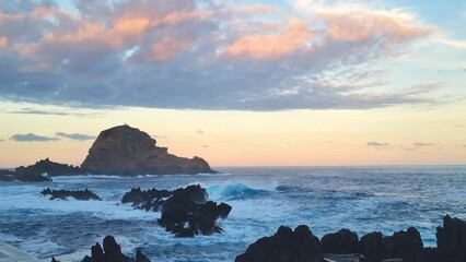 Wall Mural - A beautiful and picturesque sunset on the coast of an island in the Atlantic Ocean. Holidays on the island of Madeira. Pleasant and warm climate all year round