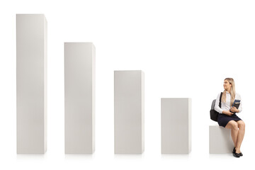 Wall Mural - Female college student sitting on a bar chart and looking at rising columns