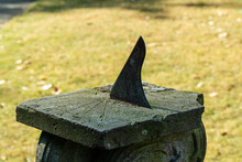 Metal And Stone Sundial In Garden