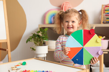 Wall Mural - Cute little girl with matching game at home