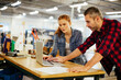 © Geber86 - Young man and young woman using a laptop while working in a printing press office