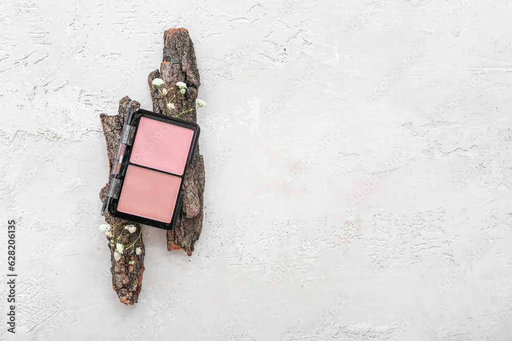 Blush with flowers and tree bark on grunge white background