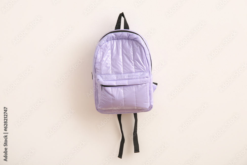 Lilac school backpack on light background