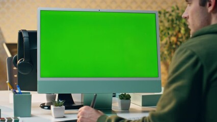 Wall Mural - Focused artist staring green screen creating tablet close up. Designer working