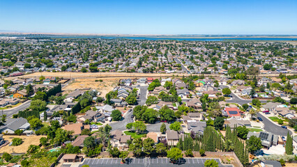 Wall Mural - Aerial Photo over a neighborhood in Oakley, California with streets, trees, houses and a beautiful blue sky