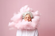 Thoughtful elderly woman with clouds in head on pink background. Concept of woman mental health, memory loss, dementia 