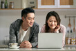 © imtmphoto - young asian couple using laptop computer together at home