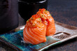 Salmon Sushi - Japanese food style on black slate background.