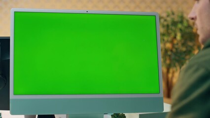 Wall Mural - Designer working mockup computer at cabinet close up. Man staring green screen