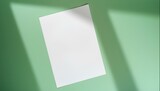 Fototapeta Big Ben - White Sheet of Paper on Soft Green Background with Soft Shadows Cast Mockup for Branding or Notes