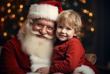Cute And Ruddy Santa Claus Holds A 4 Year Old Kid In His Arms. 