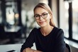 © pham - A woman wearing glasses sitting at a table