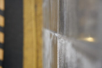 Wall Mural - Selective focus of a stone house close-up with a blurry view. Texture of a concrete surface with space to copy. High quality photo