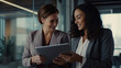 © Sasint - Shot of two businesswoman working together on digital tablet. Creative female executives meeting in an office using tablet pc and smiling.