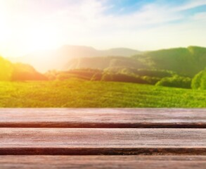 Poster - Wooden empty table top on green field background