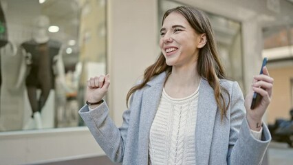 Poster - Young hispanic woman dancing listening to music on smartphone at street