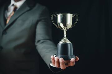 Businessman, success, company president Holding an outstanding trophy for corporate development of an investment company	