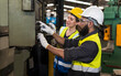 © Jack Tamrong - Beardman factory engineer worker checking main switch in industrial warehouse with woman teammates