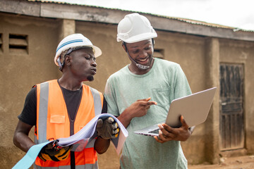 two african engineers working using a laptop