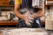 © Wavebreak Media - Midsection indian man in apron preparing bread dough in sunny kitchen at home