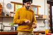 © Wavebreak Media - Indian man preparing sandwiches with avocado in kitchen at home
