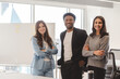 © Maria Vitkovska - Group of smiling confident multiracial business people, colleagues standing together in modern office. Portrait happy stylish successful coworkers working together looking at camera. Diversity concept