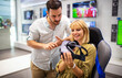 © NDABCREATIVITY - Couple enjoying with VR goggles at tech store. Shopping couple having fun at marketplace.