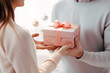 © Виктория Марьенко - A man and a woman come together to celebrate Christmas with gift giving