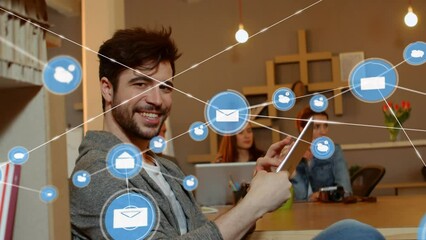 Poster - Animation of network of digital icons over portrait of happy caucasian man using tablet at office
