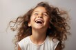 Young fictional little girl laughing candidly isolated on a plain background. Generative AI.