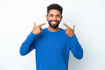 Wall Mural - Young Brazilian man isolated on white background giving a thumbs up gesture