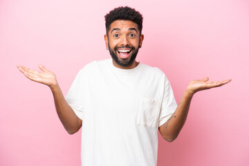 Wall Mural - Young Brazilian man isolated on pink background with shocked facial expression