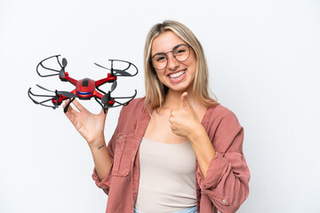 Wall Mural - Woman holding a drone over isolated background with thumbs up because something good has happened