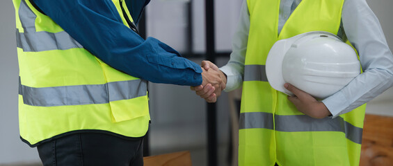 Wall Mural - Close up team young engineer handshake with partnership, customer after agreement to work together at the site, workplace, office. Business success concept