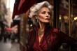 © Dasha Yurk - Beautiful elderly woman model with gray hair dressed in red clothes on an urban urban background, in the style of high fashion magazines. Generative ai.
